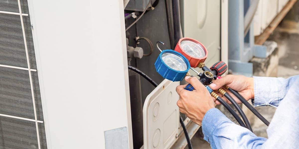 Technician servicing commercial refrigeration equipment